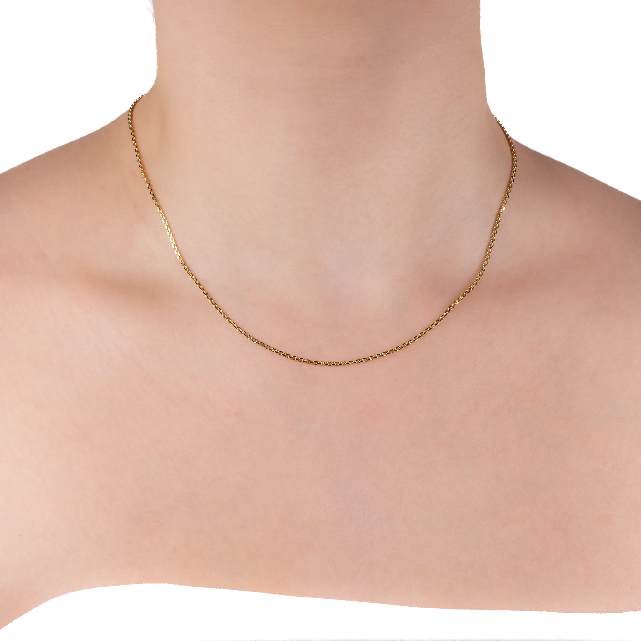 Gold necklace on a mannequin with a white background
