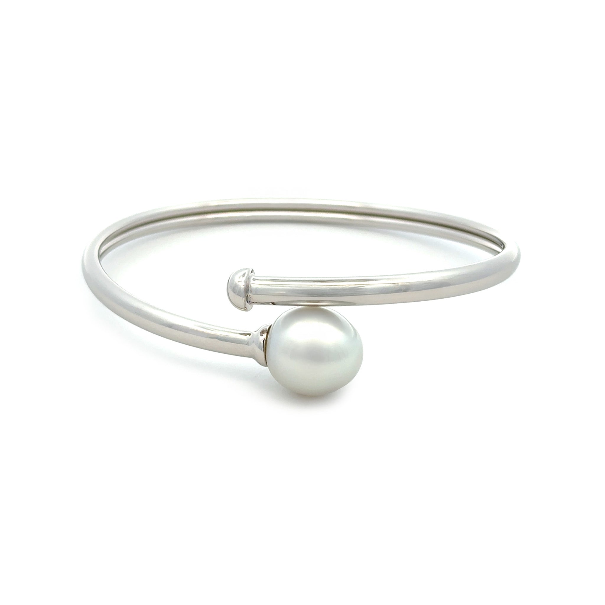 Silver bangle with a pearl on a white background