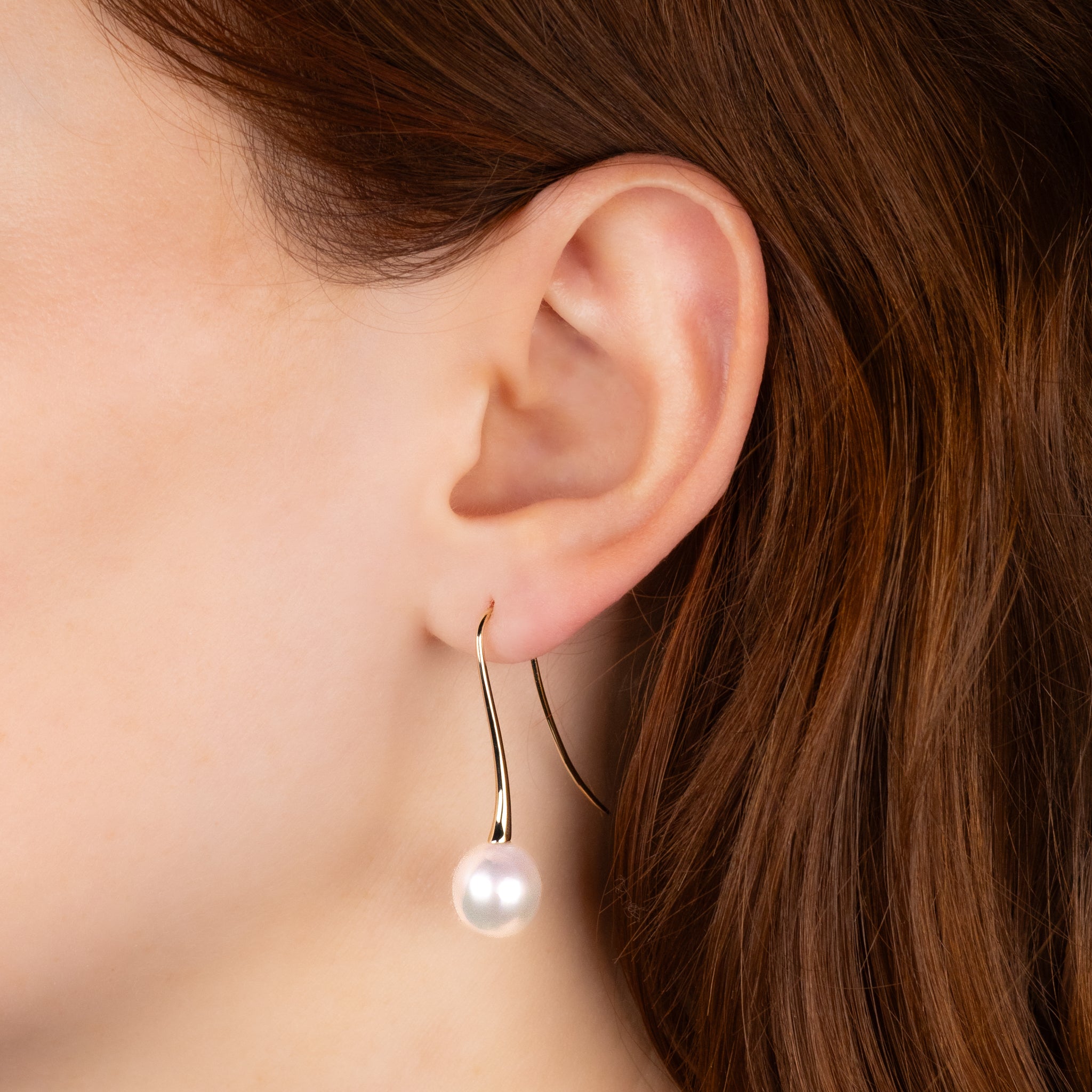 9K Yellow Gold Australian South Sea 10-11 mm Cultured Pearl Hook Earrings worn on a model