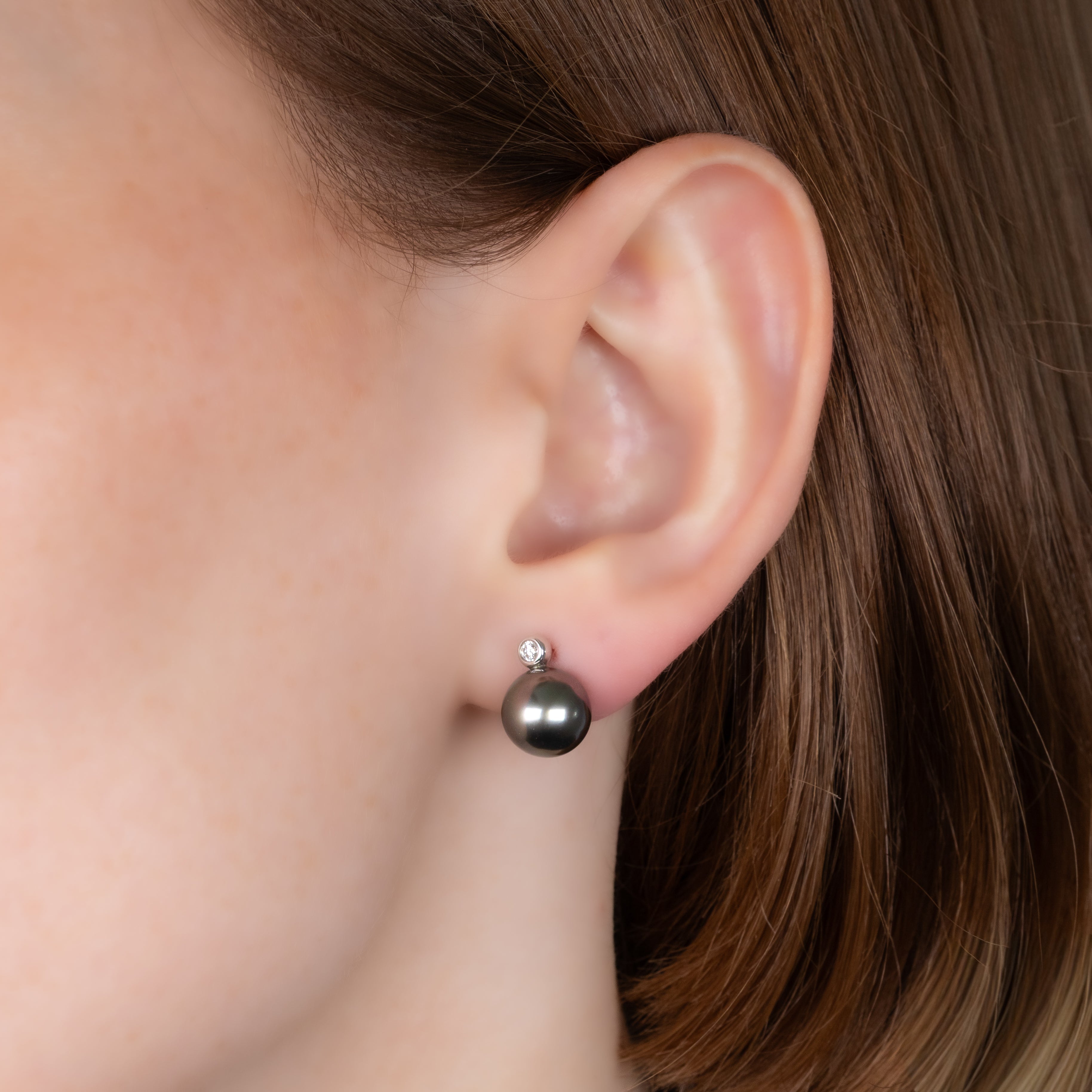 9K White Gold Tahitian 9-10 mm Cultured Pearl and Diamond Stud Earrings on a model