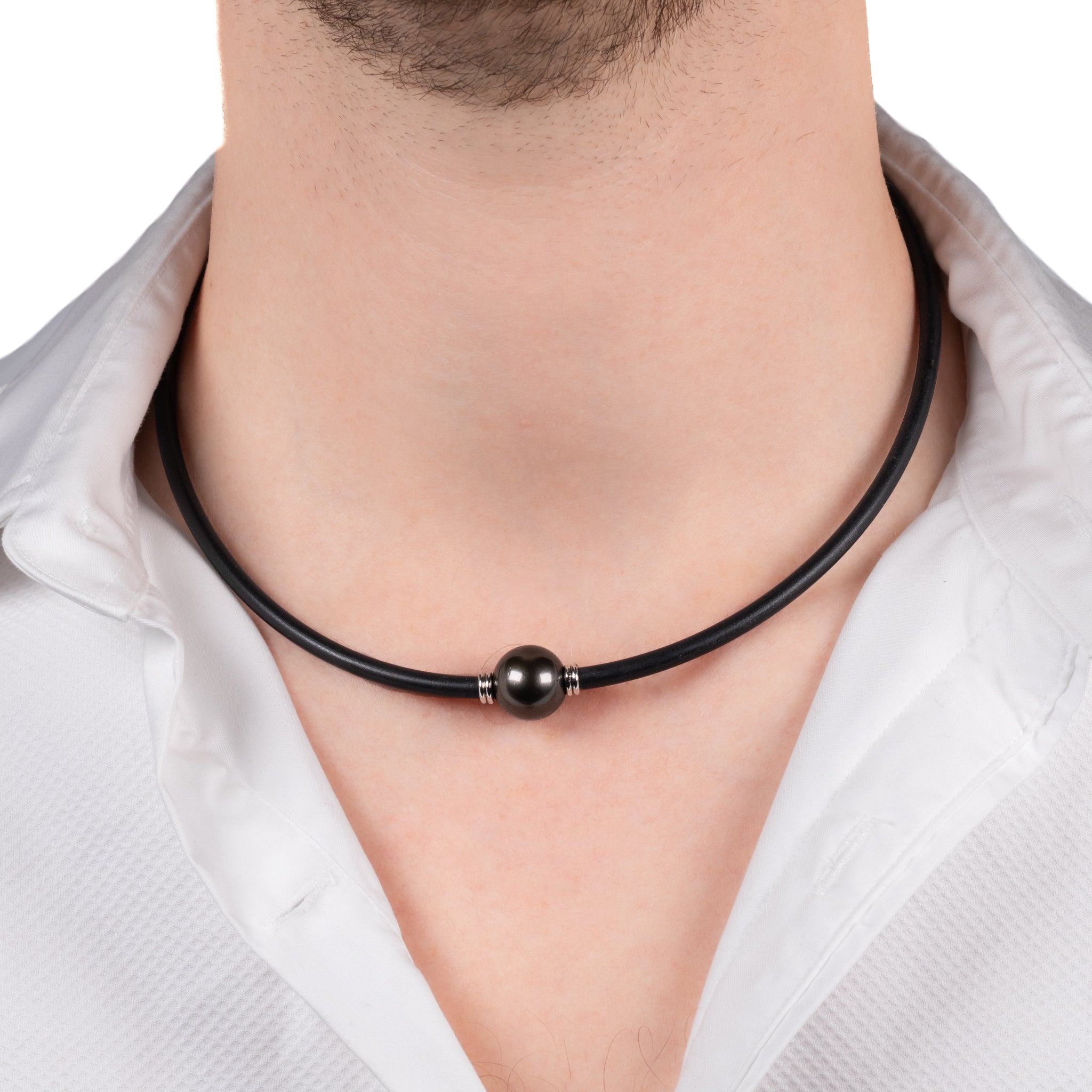Black leather necklace with a dark bead worn by a person on a white background