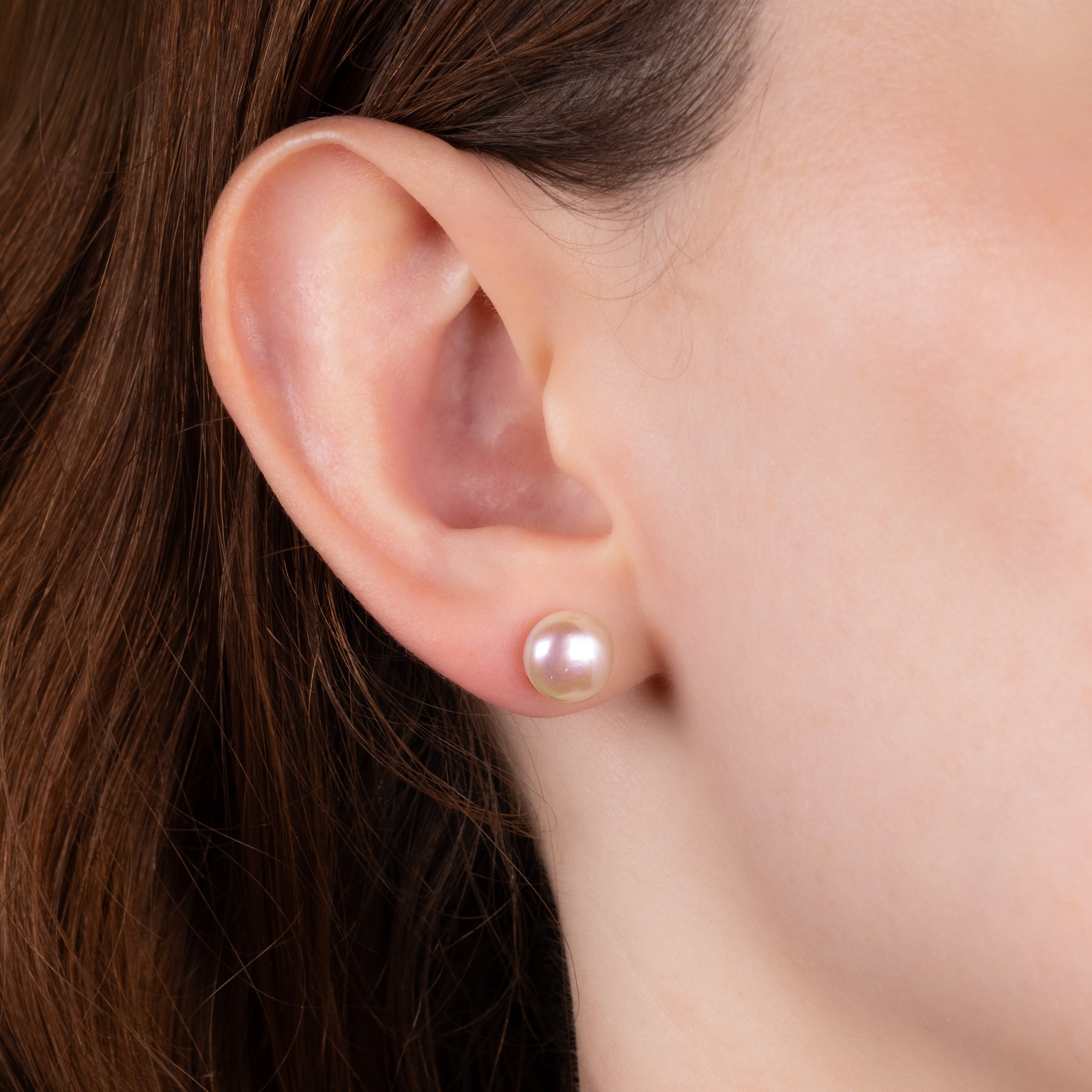 Pair of 9K Yellow Gold Freshwater 8.5 - 9mm Pearl Stud Earrings worn on a model