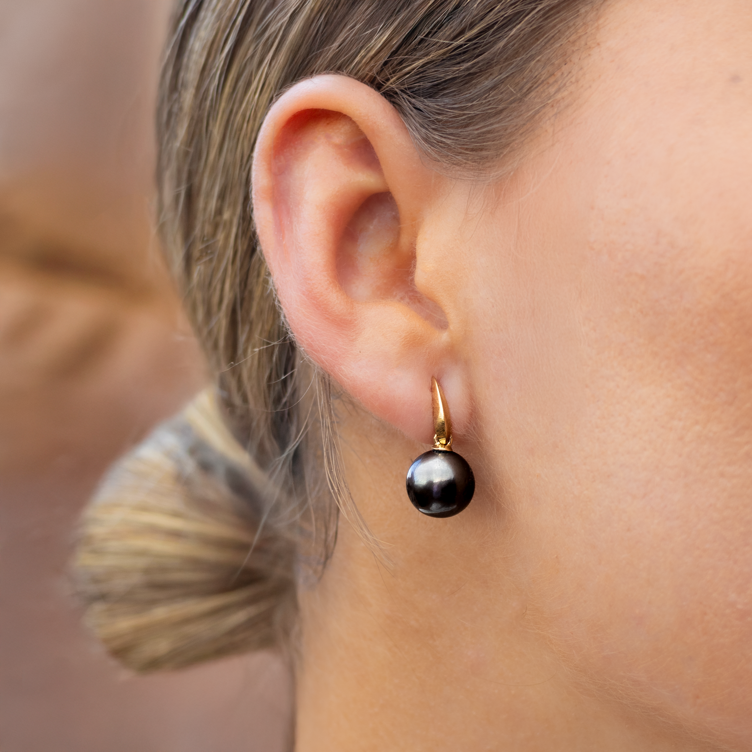 Lady wearing a Tahitian Drop Earring with her hair tied back