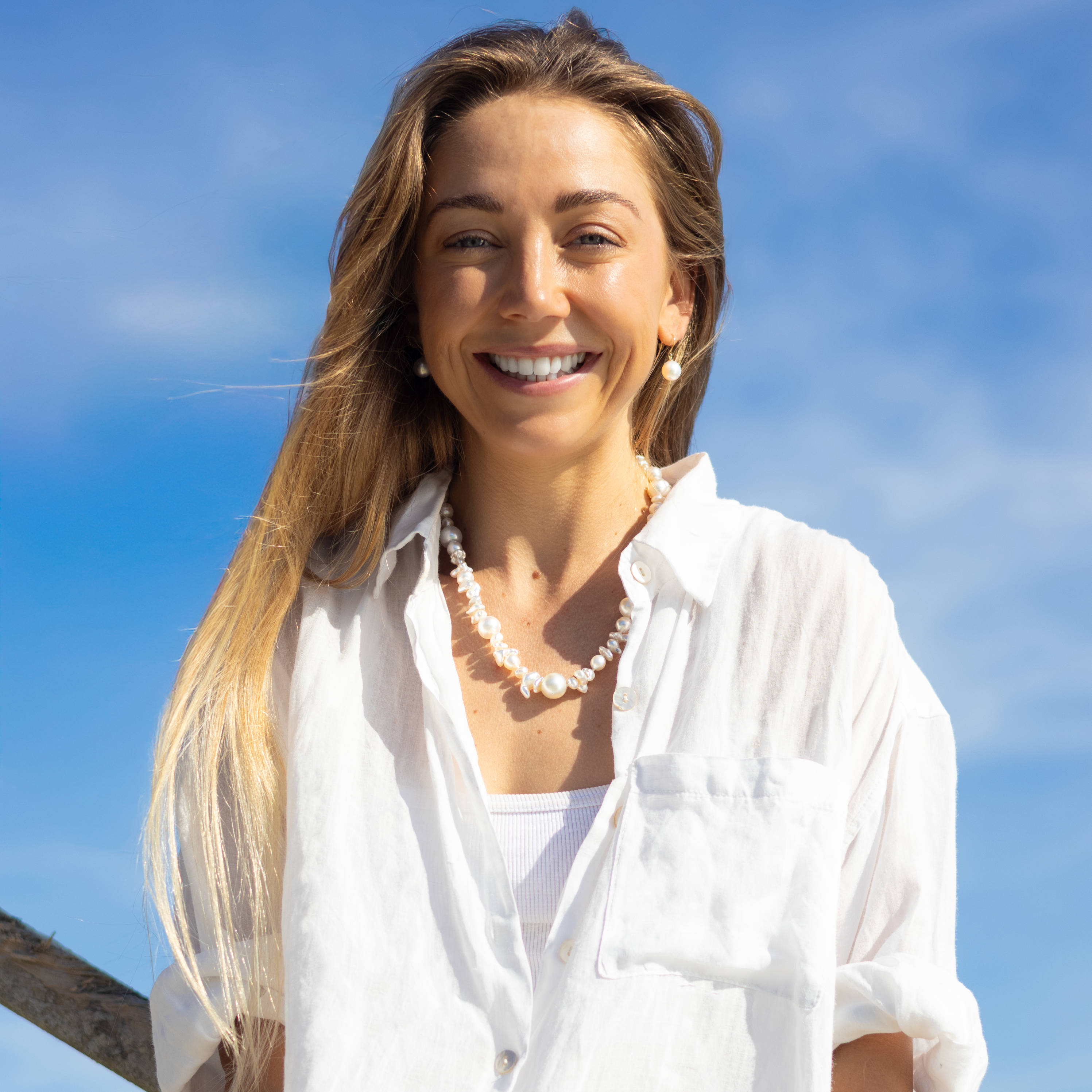 Smiling woman wearing pearls