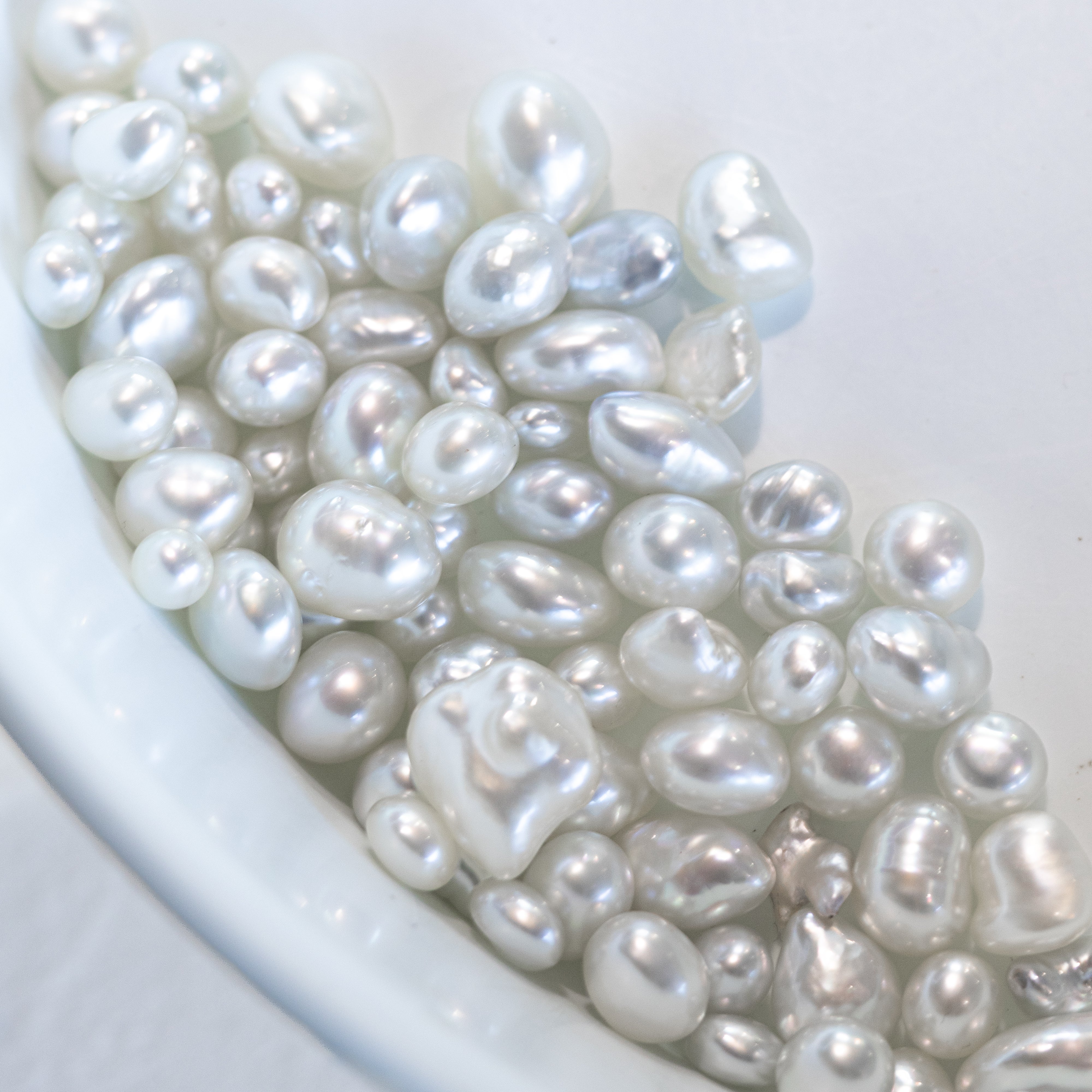 Close-up of white pearls on a white Keshi Australian South Sea Pearls as a banner background