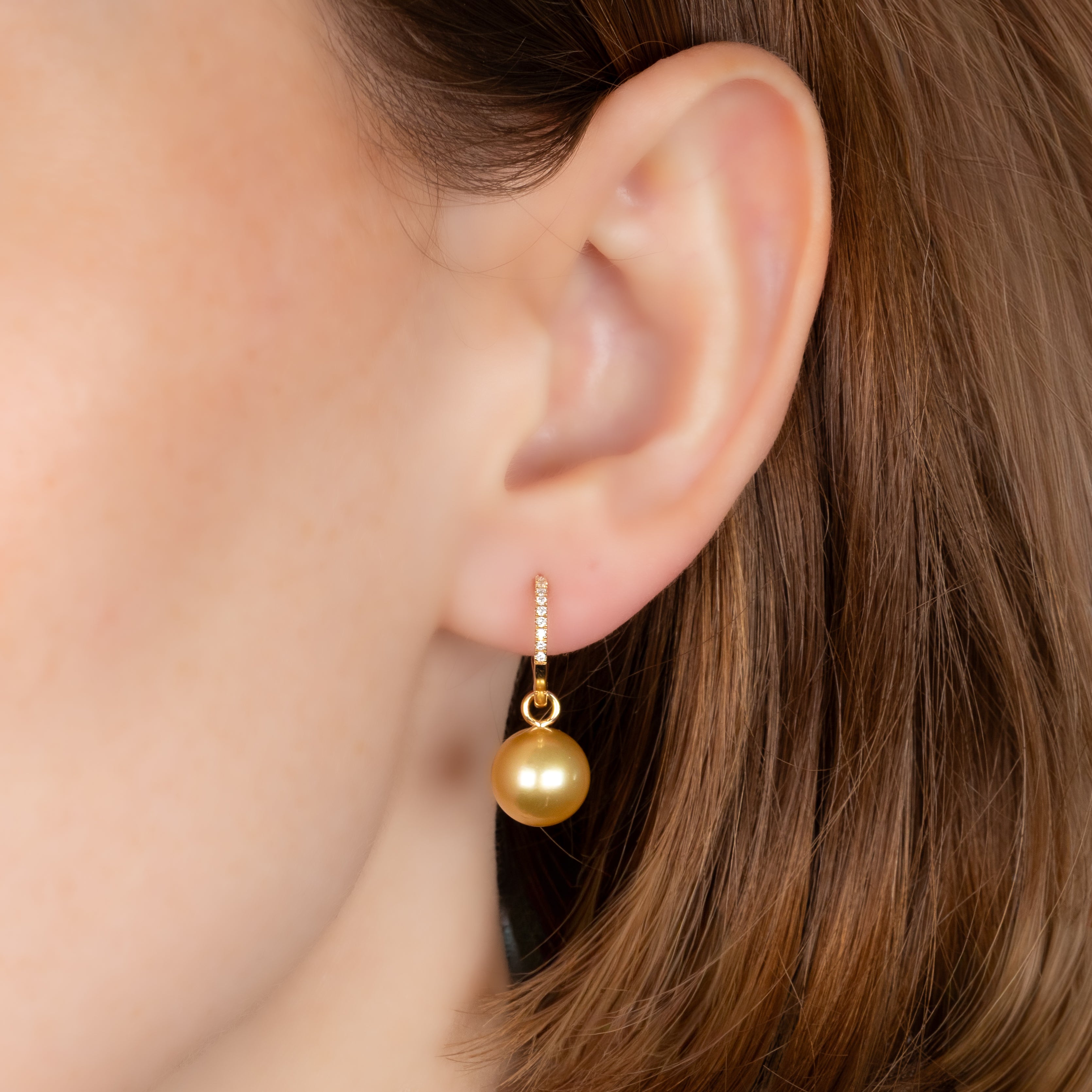 18K Yellow Gold South Sea 9-10 mm Cultured Pearl and Diamond Huggie Earrings on a model