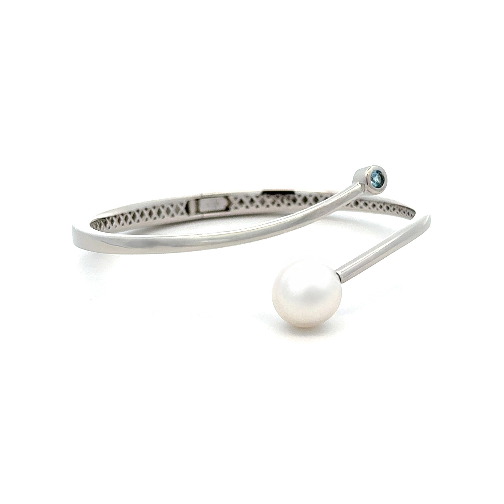 Silver bracelet with a pearl and gemstone on a white background