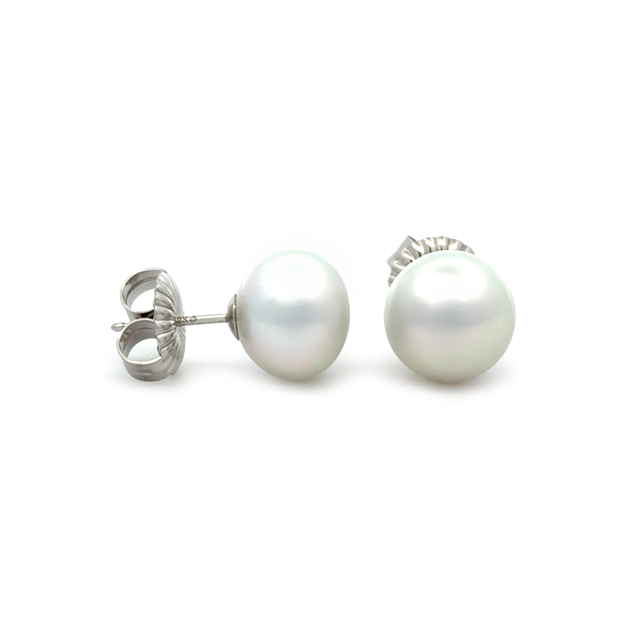 Pair of pearl stud earrings on a white background