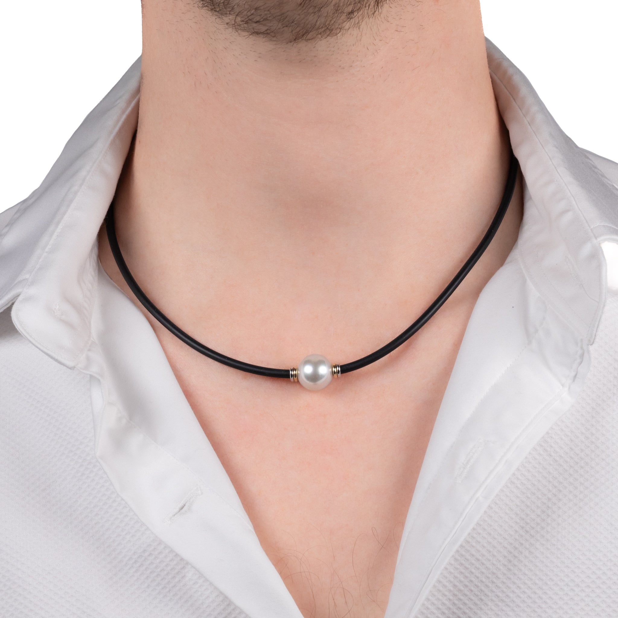 Man wearing a black leather necklace with a pearl pendant on a white background