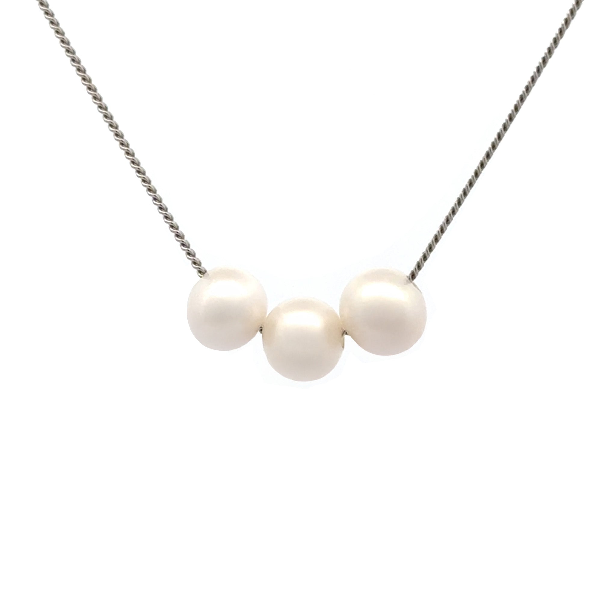 Necklace with three pearls on a white background