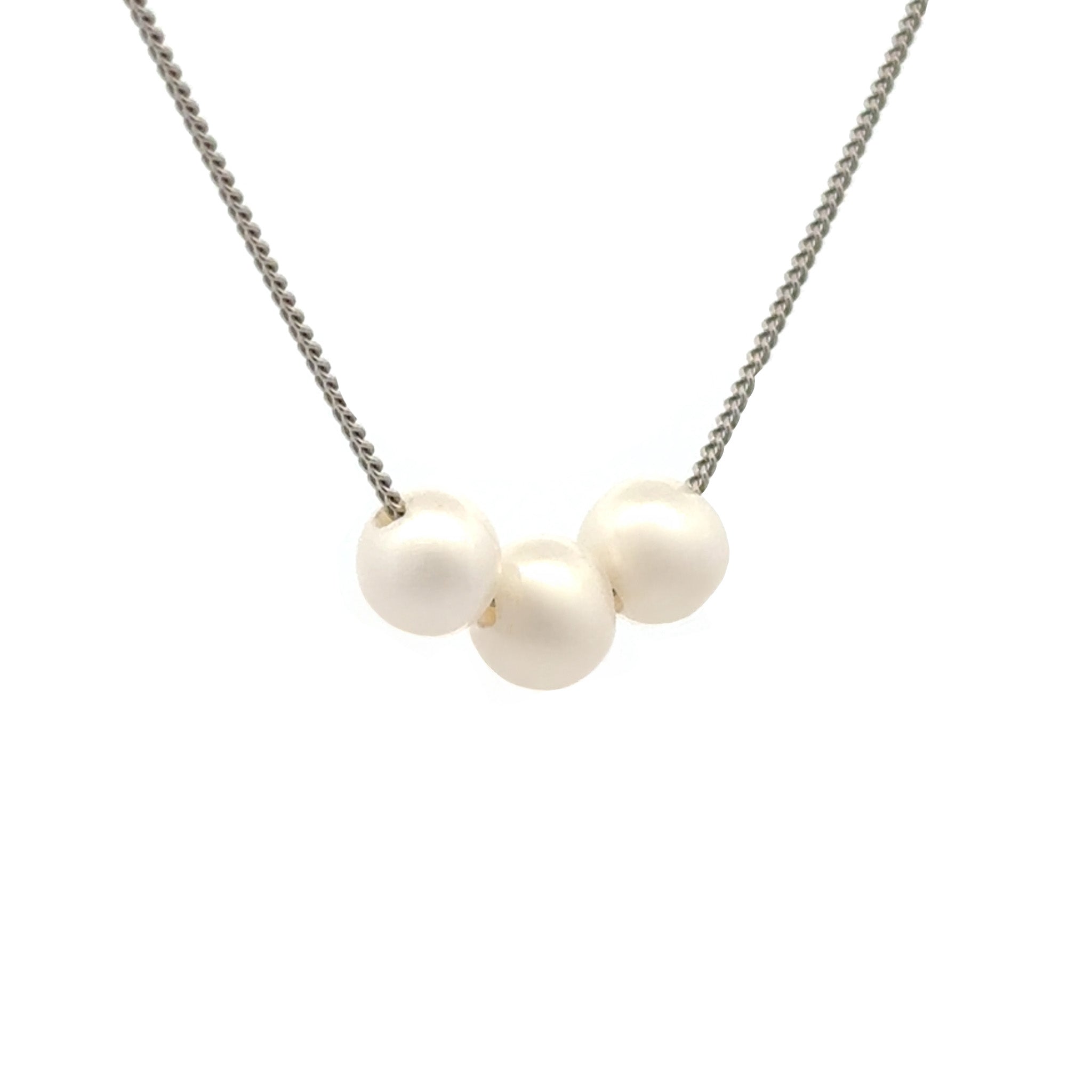 Necklace with three pearls on a white background