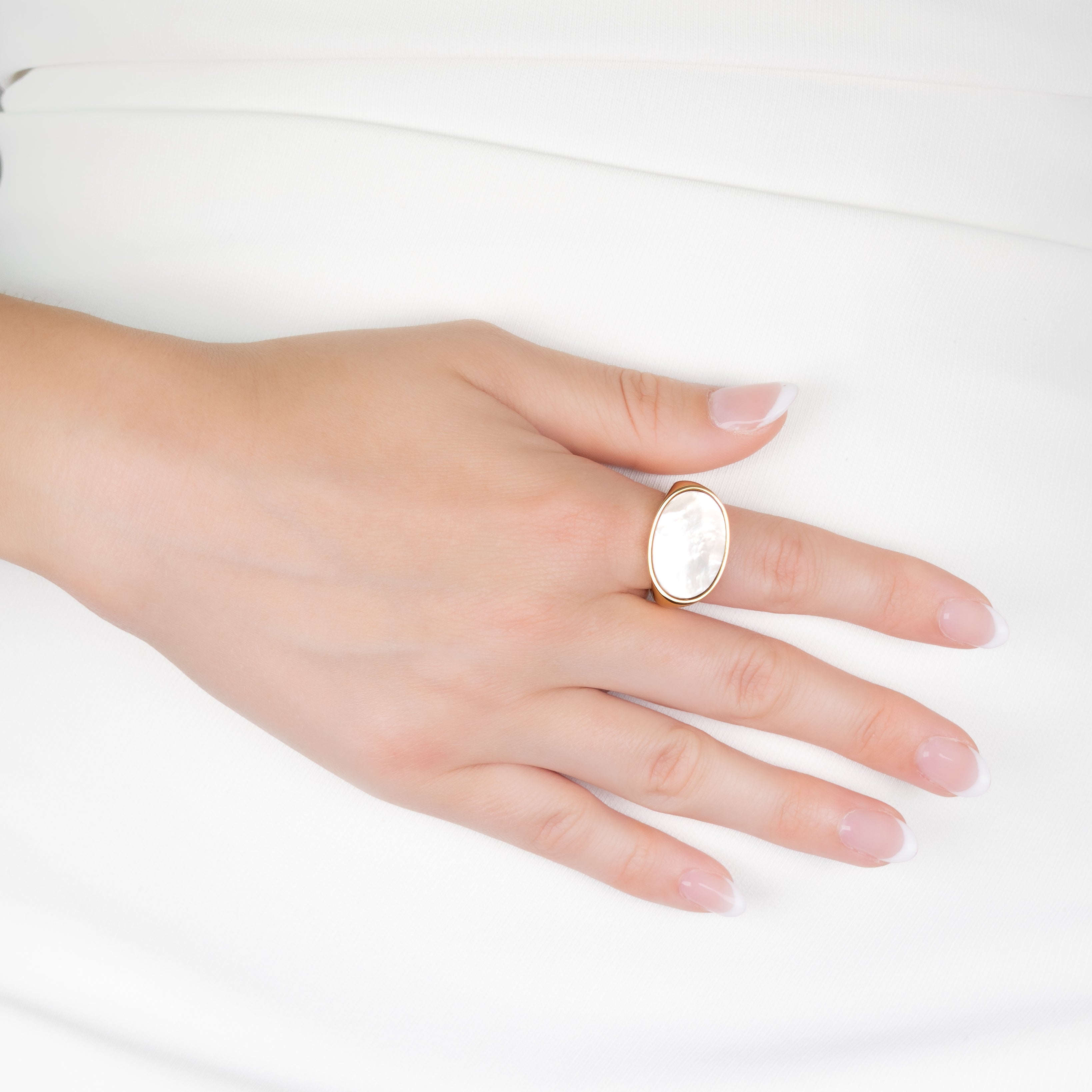 Gold Plated Stainless Steel White Mother Of Pearl Oval Ring on a model