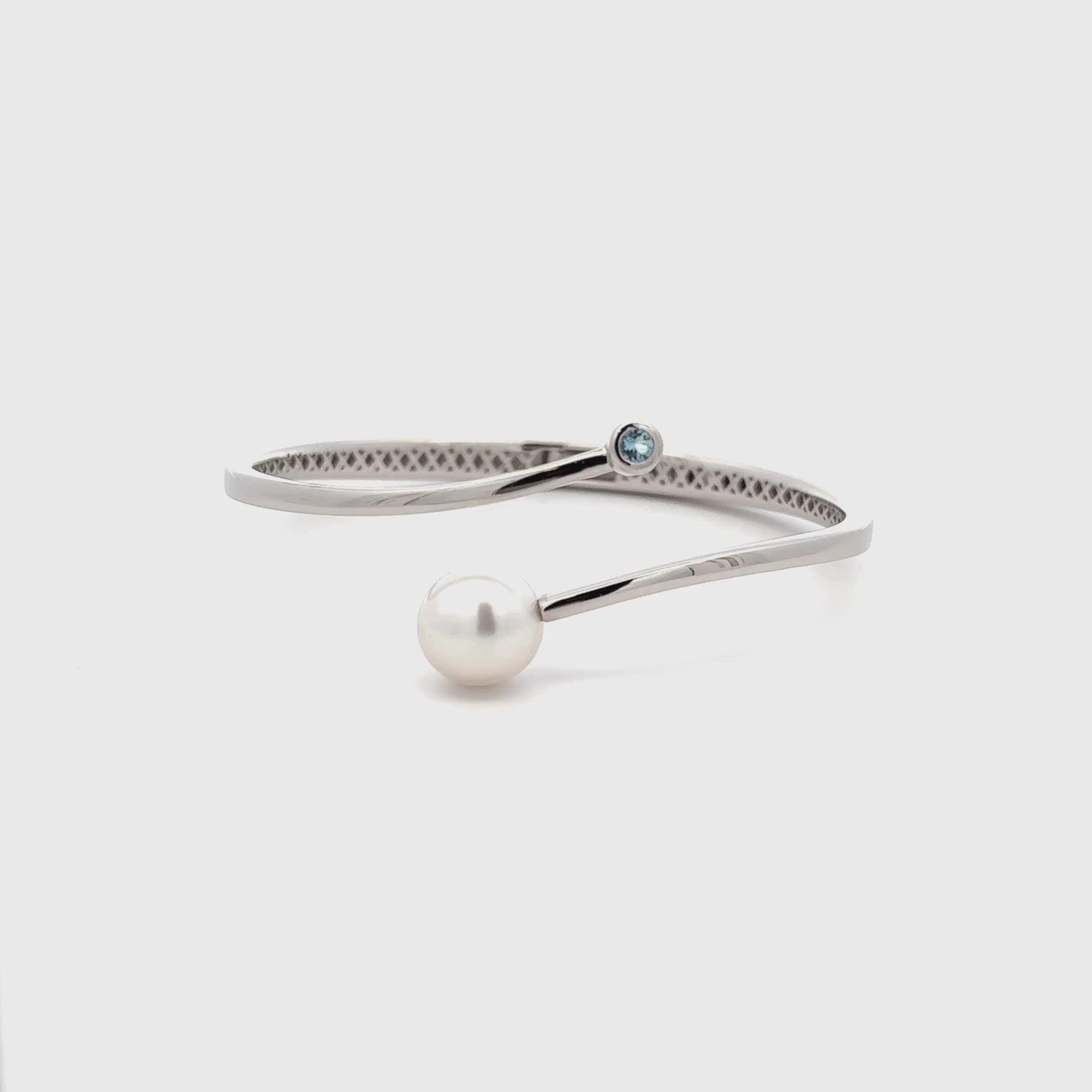 Silver bracelet with a pearl and gemstone on a white background 360 degree video