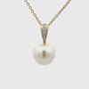 Pearl pendant necklace with yellow gold chain and diamond accents on a white background 360 degree view