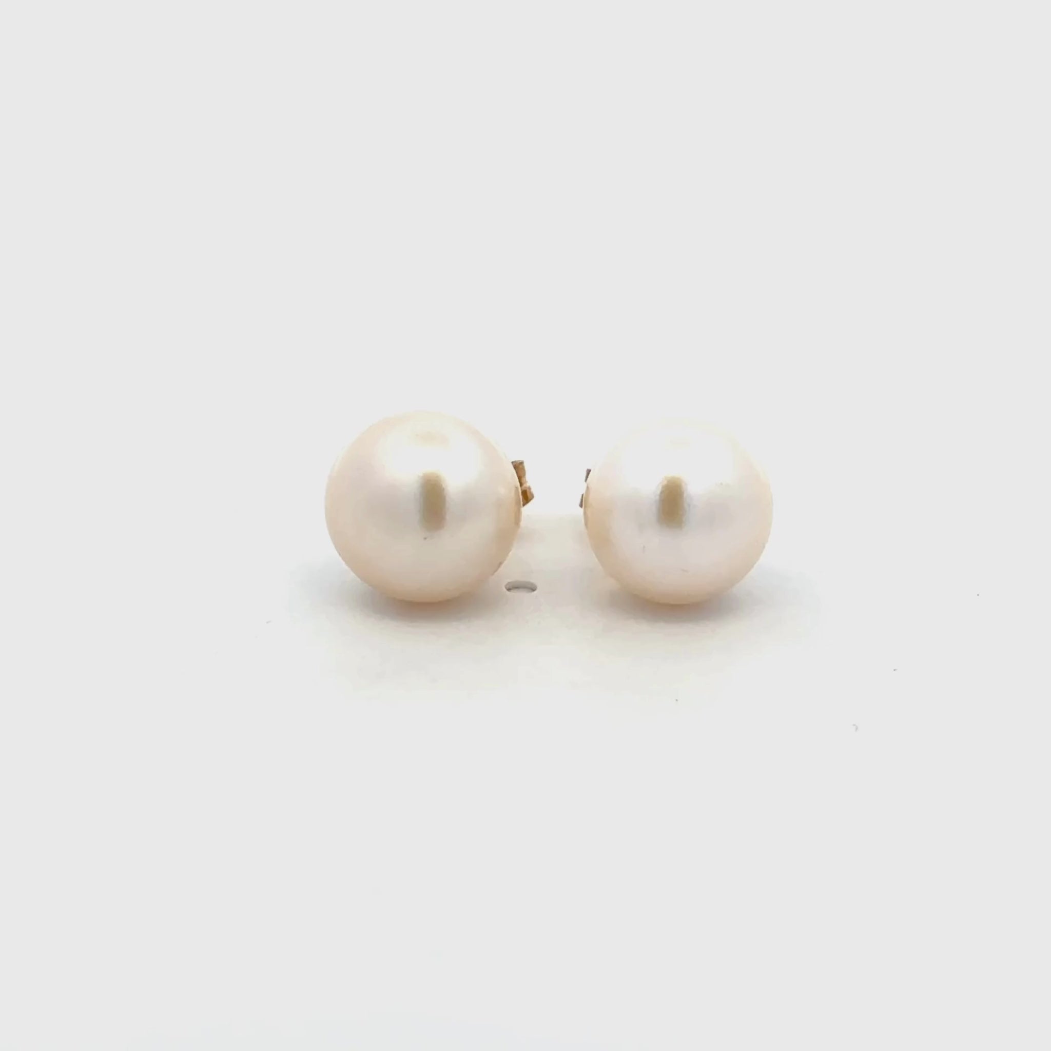 Pair of 9K Yellow Gold Freshwater 8.5 - 9mm Pearl Stud Earrings on a white background 360 degree view
